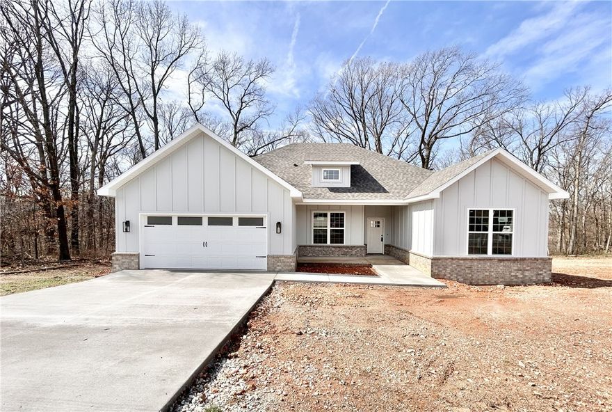 Stunning new construction home on a wooded lot with easy access to I-49! Perfectly situated just minutes from Lake Loch Lomond. Step inside to discover a beautifully designed interior with 3BD's + office, a split floor plan, & custom modern finishes throughout. Wood floors! The spacious living area showcases a beamed vaulted ceiling, creating an inviting atmosphere. The kitchen features sleek 3 cm quartz countertops, a gas range, custom cabinets, and stylish stainless-steel appliances. Retreat to the luxurious primary bath, which boasts a huge walk-in closet, a large custom walk-in tile shower, and a soaking tub. 2 covered patios. As an added bonus, receive $3,500 towards buyer's closing costs when working with the builder’s preferred local lender!