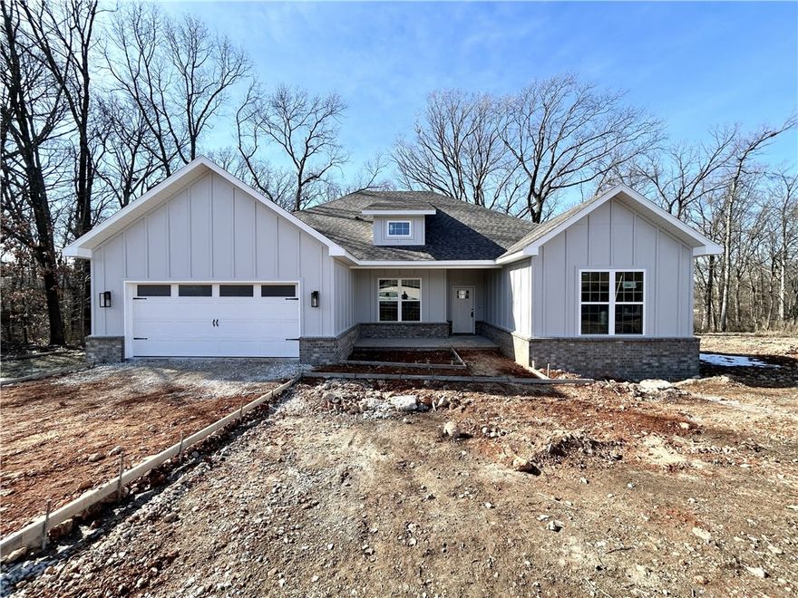 Stunning new construction home on a wooded lot with easy access to I-49! Perfectly situated just minutes from Lake Loch Lomond. Step inside to discover a beautifully designed interior with 3BD's + office, a split floor plan, & custom modern finishes throughout. Wood floors! The spacious living area showcases a beamed vaulted ceiling, creating an inviting atmosphere. The kitchen features sleek 3 cm quartz countertops, a gas range, custom cabinets, and stylish stainless-steel appliances. Retreat to the luxurious primary bath, which boasts a huge walk-in closet, a large custom walk-in tile shower, and a soaking tub. 2 covered patios. As an added bonus, receive $3,500 towards buyer's closing costs when working with the builder’s preferred local lender!