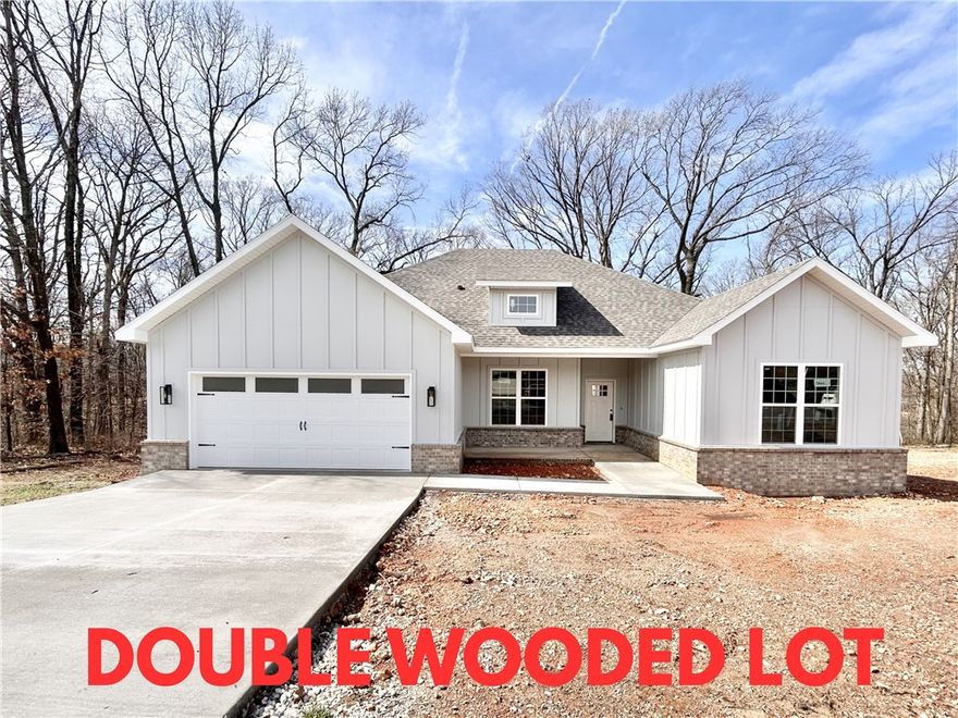 Stunning new construction home on a wooded .52 acre double lot with easy access to I-49! Perfectly situated just minutes from Lake Loch Lomond. Step inside to discover a beautifully designed interior with 3BD's + office, a split floor plan, & custom modern finishes throughout. Wood floors! The spacious living area showcases a beamed vaulted ceiling, creating an inviting atmosphere. The kitchen features sleek 3 cm quartz countertops, a gas range, custom cabinets, and stylish stainless-steel appliances. Retreat to the luxurious primary bath, which boasts a huge walk-in closet, a large custom walk-in tile shower, and a soaking tub. 2 covered patios. As an added bonus, receive $3,500 towards buyer's closing costs when working with the builder’s preferred local lender!