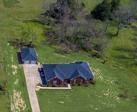 Ranch-style home with a garage, a front yard, an o
