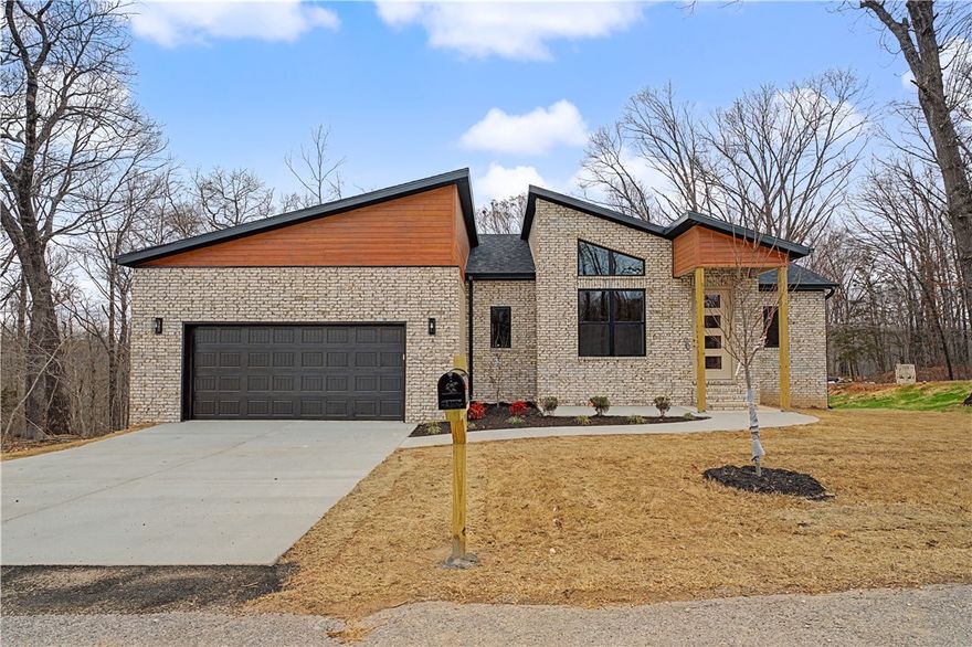 Experience modern living in this beautifully crafted new construction home located in Bella Vista, AR.This contemporary residence offers clean lines, stylish finishes, and thoughtfully designed spaces.Featuring 2 bedrooms, 2 bathrooms, and a bonus room ideal for a home office, library, or flex space, this home provides both comfort and functionality. The spacious primary suite includes a large walk-in closet and a luxurious master bath complete with a soaker tub and walk in shower. Energy Star appliances enhance efficiency while adding modern convenience throughout the kitchen.Situated in the heart of Bella Vista, residents enjoy access to incredible community amenities including golf courses, biking and hiking trails, scenic walking paths, parks, fishing, dining, and shopping. Located near the Arkansas-Missouri state line, this home offers easy access to everything Northwest AR and MO have to offer. Modern design, prime location,and exceptional amenities—this home truly has it all. (More pics coming soon)