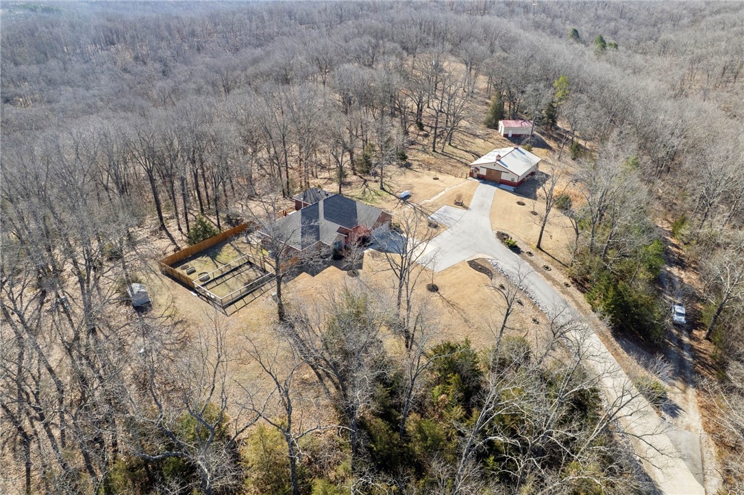 Want an escape from the city within 10 minutes of downtown Rogers? Looking for a location within minutes to Beaver Lake marinas and boat launches? Would you like a possible revenue stream or extra space for visitors? Have farm animals that will need their own space? Need a workshop or a place to store your boat and ATVs? This property has all that on 25.83 acres. This custom home was built to be energy efficient without skimping on the finer details. Schedule your viewing near dusk and you may catch the breathtaking sunsets over the tree tops.