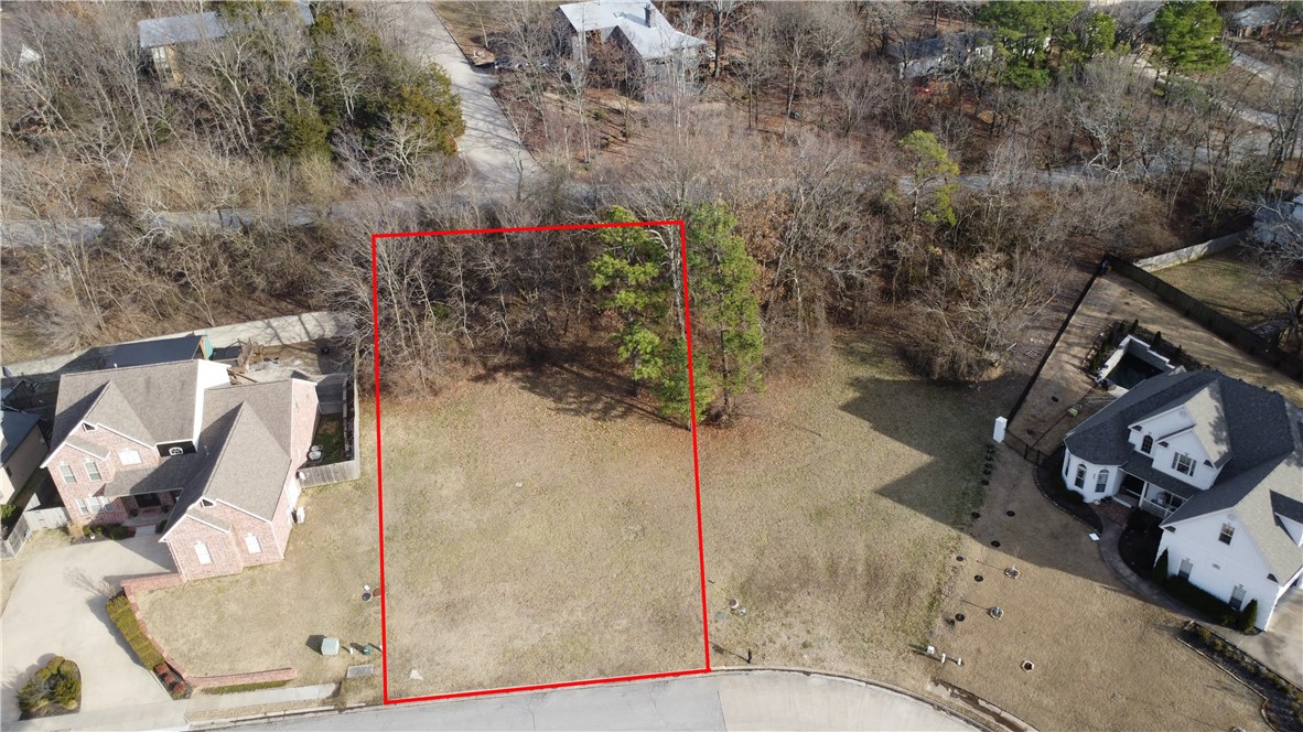 Build your dream home in this quiet neighborhood, while being right in the heart of Fayetteville! Watch the sunset over the tree-covered hills right from your front door! This building lot is located just off Mission Blvd in East Fayetteville at the base of Mt Sequoyah, near Root Elementary, shopping, parks, and trails. The new home must be a minimum of 2400 sf. Lot fronts 3 streets, possible entrance from rear.