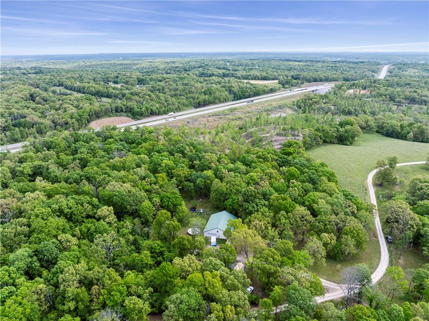 5.02 ACRES IN BENTONVILLE! Seller offering $10K closing costs credit. Private location only a short drive to Downtown Bentonville, the interstate, Coler. The privacy makes this home an ideal retreat from the hustle & bustle of daily life right here in town! Step in the front door you'll notice the remodeled kitchen, open space, & personal touches. Two living spaces downstairs &* BONUS LOFT* upstairs creates plenty of space for all your needs. This is the perfect place to raise chickens, have a garden, & make your homestead. Large pantry, if you need space for storage or you're looking to can with the food you grow here at home, you'll have plenty of space to do so with this custom pantry. For mountain biking enthusiasts, the owners have crafted their own mountain biking loop on the property, adding an adventurous touch to this already remarkable property. 8 minutes to Coler. Don't miss the opportunity to experience serenity and luxury that this secluded home on 5.02 acres offers.
