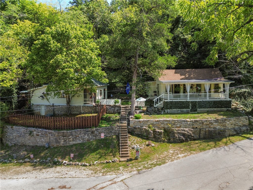 Discover a rare opportunity in the vibrant and eclectic town of Eureka Springs. This offering includes two adjoining properties with a shared courtyardāone dating back to 1901 and the other built in 1917āblending historic charm with modern comforts. 19 Jackson St is a 1-bedroom, 1-bath retreat providing peaceful serenity, with a spacious bath complete with a cast-iron tub, tiled shower, and stackable washer/dryer. Flexible living space allows for an office, sitting room, or even the option to add a second bedroom. The bedroom delights with built-in bookcases, whimsical wall murals, and apricot-toned accents. 17 Flint St has an incredible deck across the front that looks over the Grand Central. The inside is remarkably well done with custom wood work, luxurious paint colors and beautiful wood laminate flooring. See attachment for features of each property.