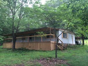 YEAR ROUND SPRING, Home, & 1 Acre M/L!! Close to the Buffalo River and VERY PRIVATE!! The 4 BR, 2 BA, doublewide is on a permanent foundation with a large 8' x 57' covered deck overlooking the spring, and a carport. The metal roof on the home was replaced in 2014. If you are looking for a nice quite place in the country then this it. Additional acreage available.