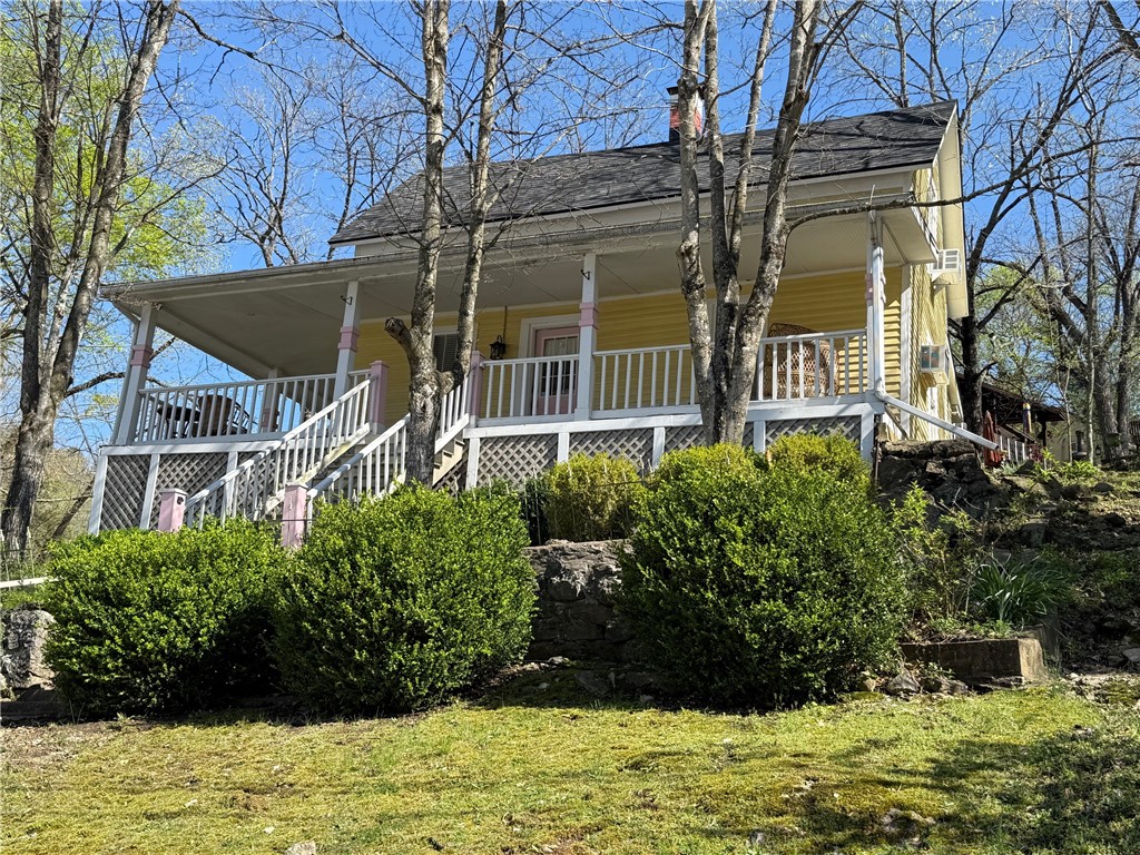 Downtown Nightly Tourist Lodging with Commercial Zoning and Off-Street Parking! Charming Victorian 2BR/1.5BA cottage built in 1890 with a large wrap-around porch overlooking Main Street. Decorated in a Boho/Victorian vibe with modern amenities you expect and a comfy atmosphere you need to relax and unwind. Enjoy the music and activities in Basin Park and other downtown venues, then crash on the front porch and rest up for your next adventure. Beautiful wood floors on the main level and new carpet in the second-floor bedroom. Remodeled kitchen with a butcher block counter, refrigerator, microwave and a coffee station. The main floor bath has a tile floor and a jetted tub/shower. The freshly painted interior is decorated with vintage furnishings and colorful artwork. Roof decking and shingles were replaced in Spring 2022. Two off-street parking spaces. Excellent downtown location making it easy to walk to your favorite restaurants, bars and shops. Can it get any better than this?