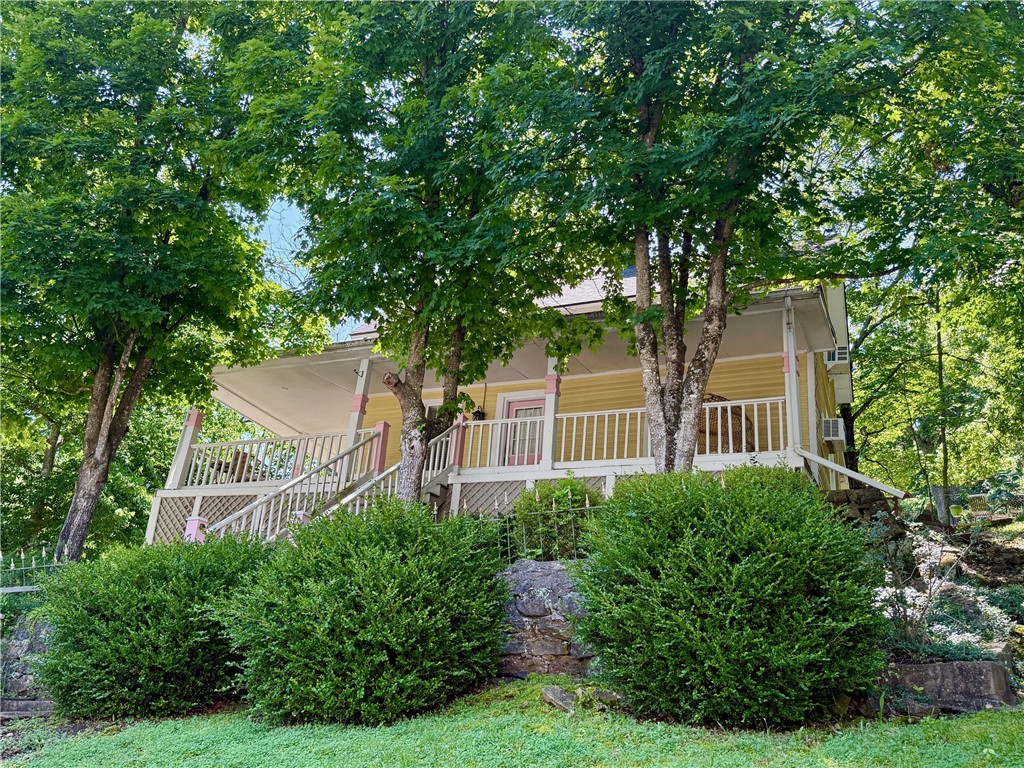 Turn-Key Downtown Nightly Tourist Lodging with Commercial Zoning and Off-Street Parking! Charming Victorian 2BR/1.5BA cottage built in 1890 with a large wrap-around porch overlooking Main Street. Decorated in a Boho/Victorian vibe with modern amenities you expect and a comfy atmosphere you need to relax and unwind. Enjoy the music and activities in Basin Park and other downtown venues, then crash on the front porch and rest up for your next adventure. Beautiful wood floors on the main level and new carpet in the second-floor bedroom. Remodeled kitchen with a butcher block counter, refrigerator, microwave and a coffee station. The main floor bath has a tile floor and a jetted tub/shower. The freshly painted interior is decorated with vintage furnishings and colorful artwork. Roof decking and shingles were replaced in Spring 2022. Two off-street parking spaces. Excellent downtown location making it easy to walk to your favorite restaurants, bars and shops. Can it get any better than this?