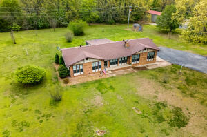 Beautiful, well-maintained, ranch-style home sitting on approximately 3.68 gorgeous acres. Family room soaks in an abundance of natural light and features brick fireplace. Spacious kitchen has gleaming hardwood flooring and connects with large dining space which walks out to great screened in patio, perfect for enjoying the outdoors throughout multiple seasons!