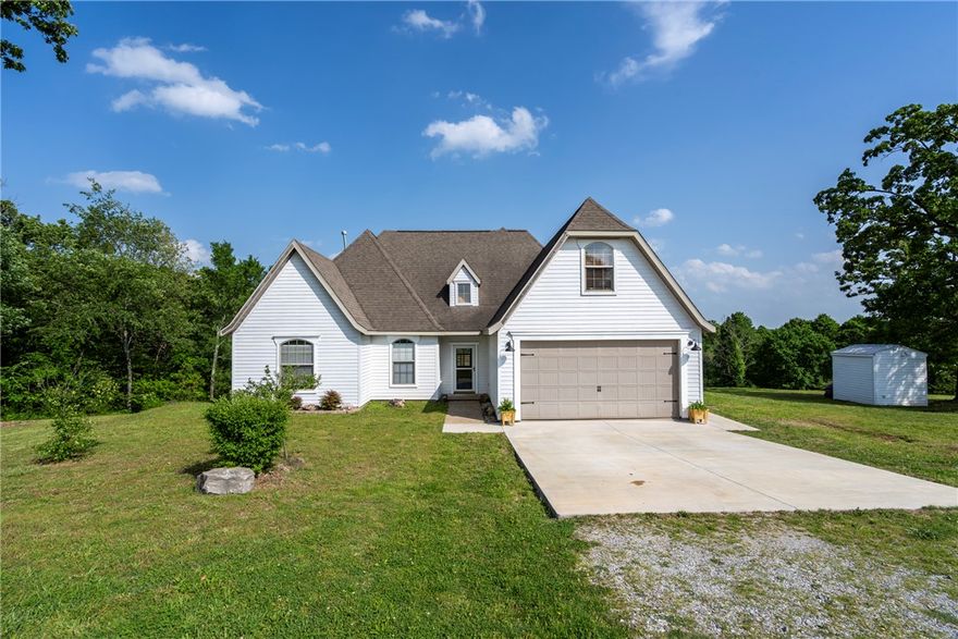 Welcome to this spacious 4-bedroom, 2-bath, two-story home situated on 2.16 acres along Hwy 59 just south of Siloam Springs! It offers a flexible layout with tall ceilings, an open floor plan, arched openings, blinds, LED lighting,  and a mix of wood flooring and ceramic tile throughout the main living areas. Fresh interior paint completed in 2026 gives the home a clean, updated feel, & the kitchen features a new dishwasher and new sink (2026). One secondary bedroom showcases cathedral ceilings for added character. Upstairs, you’ll find a large bonus room & oversized bedroom with a generous closet and beautiful views—perfect for guests, office space, or a second living area. Step outside to enjoy the partially covered deck overlooking the land, ideal for relaxing or entertaining. Well system has been rewired (2026)& all new except for the pump. New roof to be installed with an acceptable contract. HVAC is only 3 years old. Enjoy country-style living with room to spread out on over 2 acres just minutes from town!