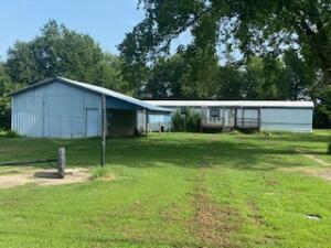 Mobile Home and shop located on 1.13 acre. Great location and neighborhood. Mobile Home needs repairs. Refrigerator and Range are included. Shop has concrete floor, electric, lean-to on side and 2 car carport on back.