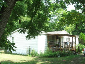 Beautiful park-like home site for this 2 bedroom 2 bath home on West Sugarloaf Creek and fronts paved state Hwy. Home was 3 BR originally and could be converted back to 3 BR's. Refrigerator, range, dishwasher, washer & dryer remain with property. Covered porch and deck. Carport, 2 sheds, Artesian well. Great location between Harrison and Bull Shoals Lake!
