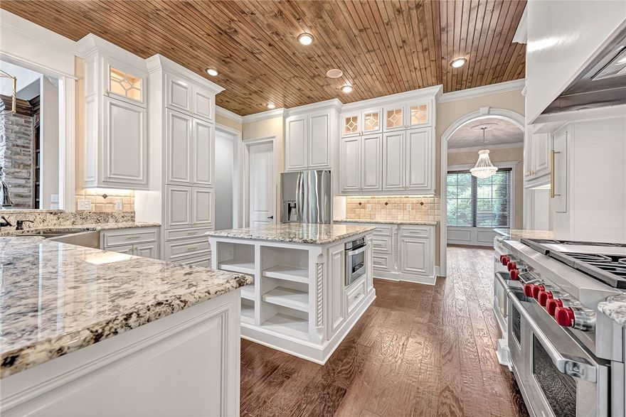 Stunning home on an acre lot in the prestigious Versailles subdivision in Centerton, only 4 miles away from Walmart HQ and downtown Bentonville. This modern masterpiece has an abundance of natural light, high-end finishes, iron doors, tall ceilings, & wood floors throughout. On the main level, you will find the primary suite, office, kitchen, living area, & guest bedroom, while all other bedrooms and media room are on the 2nd level. Pinewood tray ceiling, tall windows overlooking the pool, designer sinks, walk-in closets, & tiled shower offer luxury and privacy in the primary suite. A large island, maple custom cabinets, a gas range with 6 burners & grill, walk-in pantry, wooden vent hood, & ceiling accents complete a chef's dream kitchen! Imagine a summer afternoon in a 9' gunite saltwater pool, deck, and cooking in the back patio kitchen near the stone firepit. This home has a lot to offer, including fruit trees, an irrigated yard, & French drains. Bedroom upstairs newly added - carpet to be installed soon.