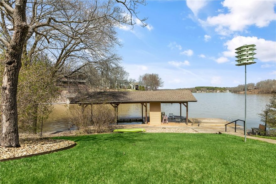This Custom home by O.A.K. home builders has BOTH desirable features of a LAKEFRONT home: Fabulous VIEWS from almost every room AND easy walking access to the COVERED BOAT DOCK & LAKE with approx. 144 feet of shoreline! Upgrades include: stainless steel appliances /granite counters /Pella windows / fantastic screened porch /composite decking /walkout basement/ lovely koi pond. Large Hobby/ bonus room in lower level has extra cabinets & built in counter area with many possible uses!  Home has 414 sqft unfinished large mechanical/storage room in lower level & could be a workshop. Concrete pathway from house leads to the Dock with covered boat slip with storage & platform deck area. Lovely screened porch with awesome VIEW leads to deck & stairs.  Beautiful Koi pond creates a serene feeling with patio area around it.  New roof 2022, new water heater 2022, new composite deck 2019, block seawall was updated in 2007, septic is 2 BR Granite counters in bathrooms too! Very well maintained home with so many great features.!