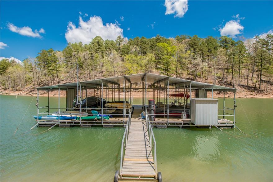 STUNNING LAKE FRONT CUSTOM HOME NESTLED ON 1.89 ACRES WITH SHARED BOAT DOCK, OFFERING 2 SLIPS, SWIM DECK & LIFT!!  Gracious floorplan featuring 4 bdrms, gentleman's study w/fp, open living area & dining and gourmet kitchen w/granite, ss appliances & banquette seating!  The main level also boasts a well appointed master suite and an additional bdrm w/en suite.  Spacious lower level accommodates a living area w/built ins, half bath, 2 guest suites plus an exercise room.
Additional amenities include wood floors throughout, built ins, 4 car garage w/workshop, hot tub and generator!  Expansive decks with peaceful lake views and serene property with direct access to a shared dock with 10x24 & 10x26 slips with electrical!  NEW MAIN LEVEL HVAC 2018 AND ROOF 2019!