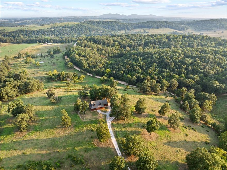 If you’ve been dreaming of wide-open space & peaceful views, this 28± acre country property near Harrison, AR delivers everything you’ve been searching for. Picture quiet mornings by one of four ponds, evenings watching deer graze, & plenty of room for animals or kids to roam. The land is fully fenced & cross-fenced, ready for horses or cattle.

The existing home gives you a head start on creating your dream homestead or weekend retreat. Inside, you’ll find 3 bedrooms, a potential 4th, 3.5 bathrooms, & a full basement perfect for storage, hobbies, or additional living space. The wraparound porch is made for slowing down & soaking in the stillness of country life.

Located 10 minutes from Harrison, this property offers a mix of privacy & convenience. Whether you’re looking to raise animals, ride ATVs, or live a self-sufficient lifestyle surrounded by nature, this Ozarks retreat checks every box. Bring your animals, your outdoor toys, & your vision—this is the peaceful acreage you’ve been waiting for.