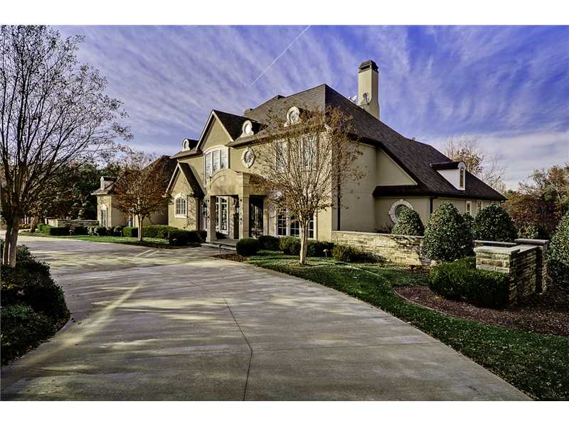 Gated custom home with 3.27 acres in the middle of town. Two running creeks bank the home. Formal office with coffer ceiling. Elegant dining room, carved crown molding and a custom wrought iron staircase. 4x4 marble floors, walk in wine cellar, designer,kitchen, five bedrooms, master bath floors are heated and the sinks are illuminated, media/ theater room has five TVs and a wet bar. The playroom is painted for a prince and princess. The guest home is finished out the same as the main house with one