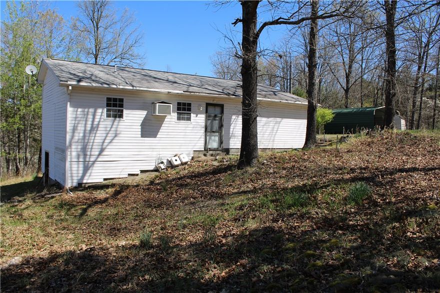 MINUTES FROM LAKE NORFORK ACCESS! This amazing property is sitting at the end of a dead-end road and touches the government strip! Located minutes from town and unrestricted! You will love all of the beautiful fruit trees and gorgeous dog wood trees.  Featuring two bedrooms, two full baths, sunroom, 8x8 green house, and a detached carport. Large Walk-in cinderblock crawl space with Water heater and well pressure tank, plus extra storage space.  Home is waiting for you to come show it some love and bring it back to life! Property is sold as is.