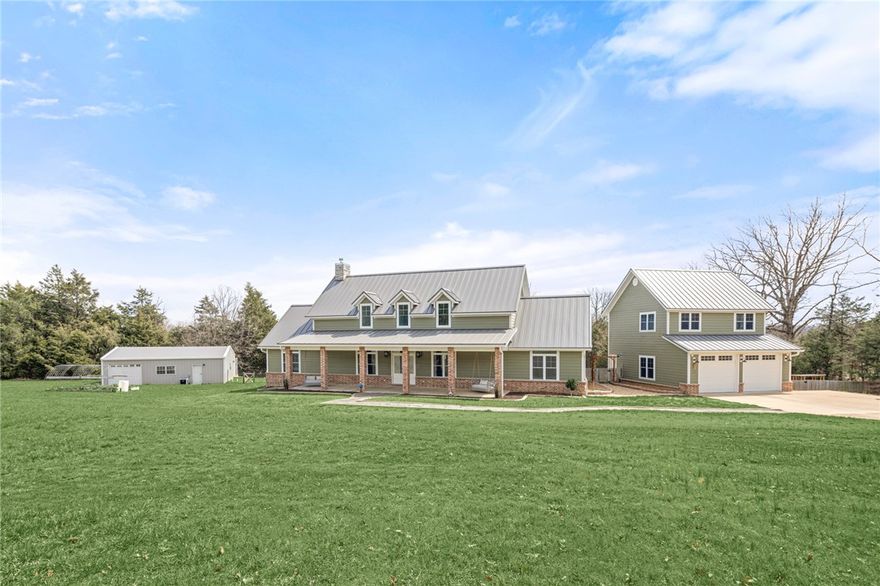 Gorgeous Country Estate with Shop & Saltwater Pool! This 2019 farmhouse sits on 3.7 Acres w/many upgrades throughout. Large covered porch overlooks a landscaped front yard w/swinging daybeds. Inside, great room features an open layout w/vaulted ceilings & Luxury Vinyl Plank flooring. Kitchen boasts a large island w/granite counters, built-in fridge & electric range. Living room has fireplace & built ins and leads to large sunroom to enjoy the scenic surroundings. Saltwater pool, spacious patio & built in outdoor kitchen. Primary bedroom has a custom double vanity, walk-in shower, and his & her closets. Two guest bedrooms share a large bathroom. Detached garage has an upstairs bonus space w/full bath, perfect for an in-law suite or home office. 1,208SF shop offers storage and workspace w/a full kitchen, bathroom & wood stove. Updates include new HVAC & Roof in 2023. Property is conveniently located near Hwy 62 w/easy access to Dwntn Rogers, I-49, and Beaver Lake. Contact agent for full list of upgrades & amenities.