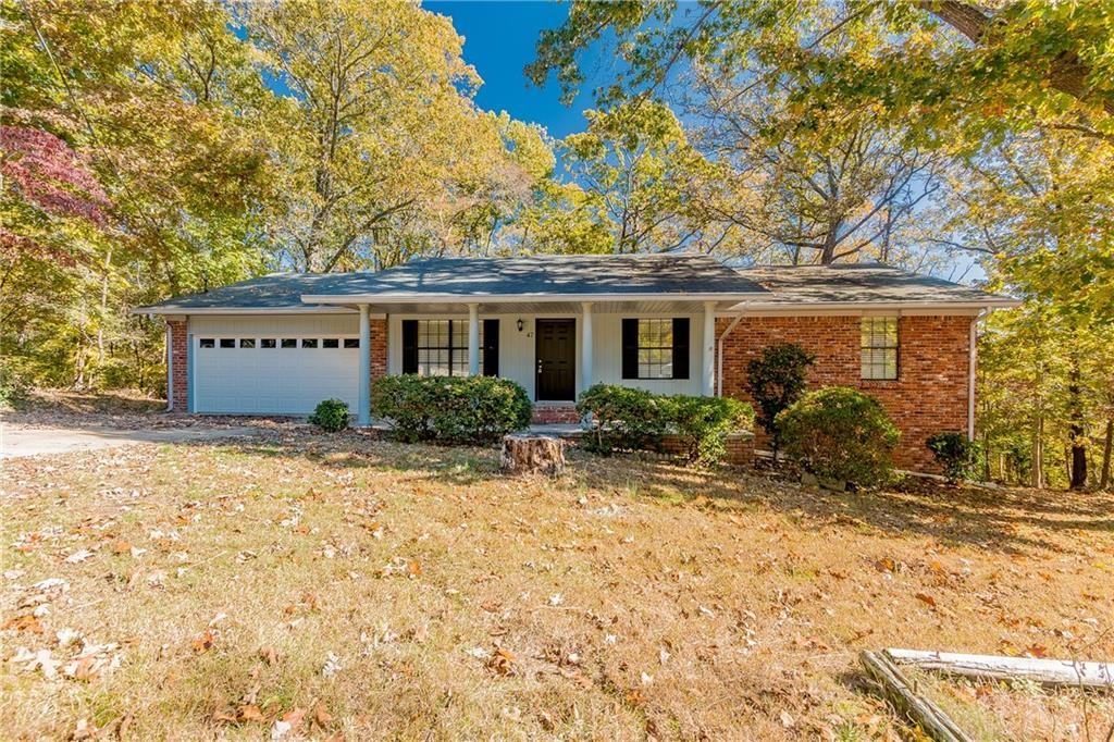 Discover this spacious 3-bedroom, 2-bathroom home with a 2-car garage in Bella Vista! This property offers a wealth of features. The kitchen is a food lover's dream, complete with granite countertops, white painted cabinets, a tile backsplash, and stainless steel appliances. The bathrooms also feature granite and custom tile showers. A beautiful rock fireplace is the focal point of the large living area, adding undeniable charm to the home. Additionally, you'll find more space than you can imagine, including a workshop area on the lower level.