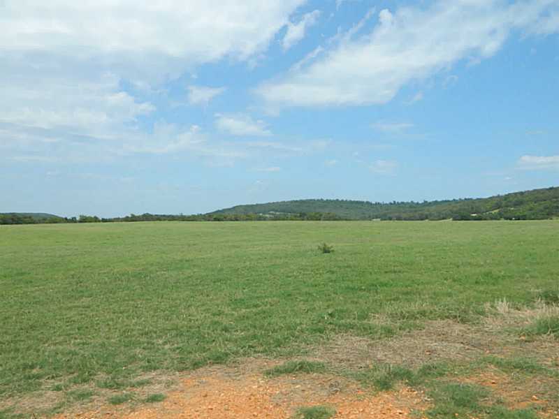 23 ACRES OF FLAT, OPEN PASTURE LAND, FENCED AND CROSS-FENCED. RURAL WATER AT THE STREET (20 OR SO ACRES WITH ROAD FRONTAGE). NATURAL GAS AVAILABLE.