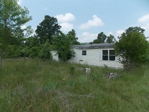 3 BR 2 BA doublewide in need of repair. Mobile is setting on great spot to build a house. Mobile can be moved out giving use to septic and well.