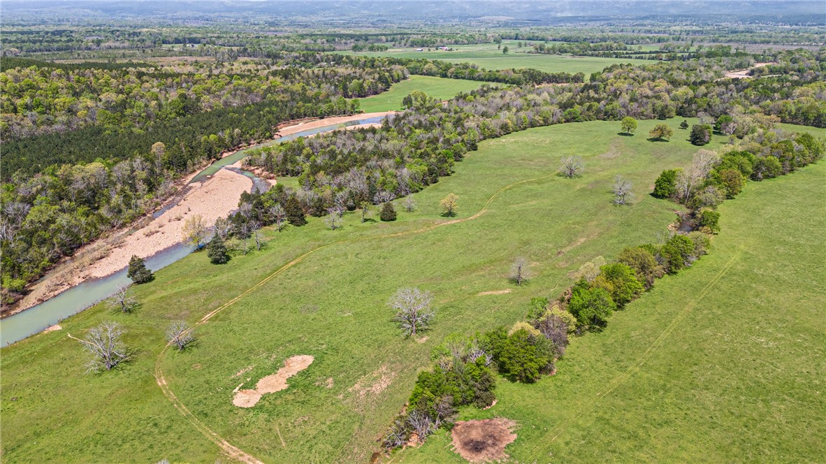 Stunning Home and Land for Sale Near National Forest Rare opportunity to own a remarkable 241 +/- acre farm, minutes from the breathtaking national forest. This property features over 1 mile of pristine Gafford Creek frontage, providing not only stunning views but also excellent recreational opportunities. The land includes roughly 170 acres of maintained pasture, ideal for grazing livestock or cultivating crops. The property is equipped with functional working cattle pens, making it perfect for those looking to manage livestock efficiently. Water supply is abundant, with the house connected to city water and a well system dedicated to livestock needs. The charming 1,800 square foot home offers 3 bedrooms and 1 full bathroom with a fireplace. Whether you are seeking a peaceful retreat or an active farming lifestyle, this property combines both in a unique package. Don't miss this chance to own this exceptional piece of land with unparalleled access to nature and all the amenities needed for rural living.