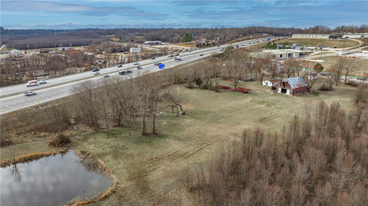 Commercial property with I-49 visibility in Fayetteville. 1.75 acres MOL - subject to lot split approval with access easement from W Van Asche Drive. Capitalize on enormous growth in this area. Zoned R-A currently, however future land use suggest Urban Center. Bordering property all zoned C-2. Taxes are estimated. Call agent for more information.