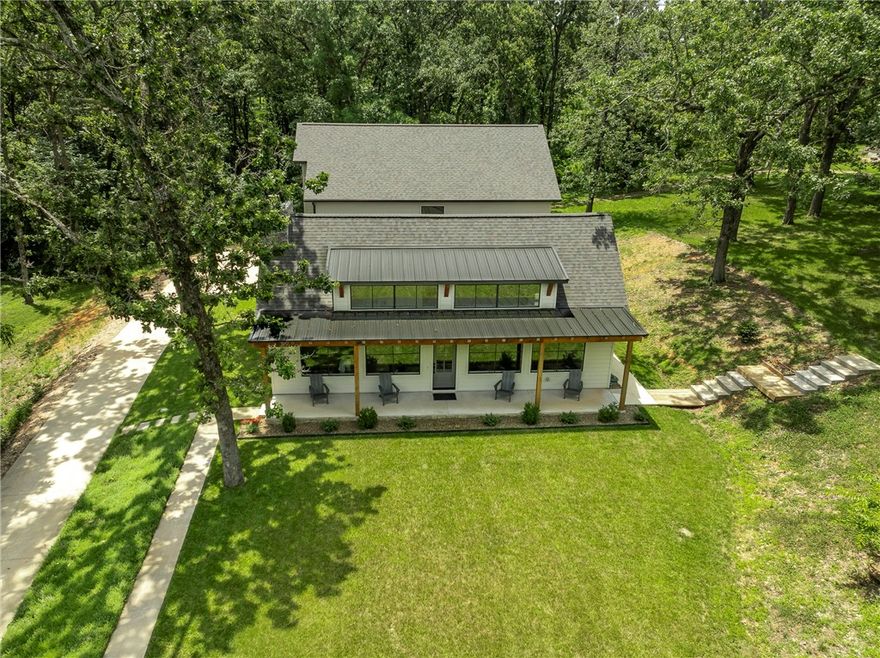 Peaceful Serenity. Country living on over 7.5 acres with your own barn and room to do what you want. This newer custom built home is so well planned. From the moment you pull into the drive you feel the calm. The charm is undeniable. Walking through the front door you notice the quality of the craftmanship and finishes. Big windows, high ceilings, gorgeous cabinets, the natural light, the colors... gorgeous. The main level living room, dining and kitchen is an entertainers dream! The first floor oversized laundry room with room for a planning desk/ hobby room is so unexpected. The primary bedroom suite is perfect with a big walk in closet and an amazing shower with its own heater. Upstairs you will find 9' ceilings, a very large bonus room, three bedrooms, a full bath, and a flex space you can use as a gym, office or playroom. This home has great closet and storage areas you don't want to miss. Bentonville schools!  Welcome home!