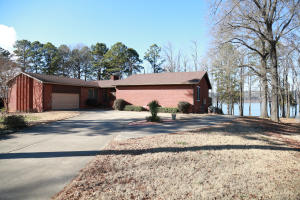 On the lake with an amazing view! This 4 bedroom 3 bath home features a full walk-out basement with covered patio, a large sunroom, formal dining, 2 kitchens and 2 fireplaces! The stamped-glass entryway is very welcoming to your guests and the large deck is great for entertaining. And better yet, how about your very own boat dock! Fish from your backyard! What a great way to enjoy those long summer nights with friends and family! Call Carol Ford at 858-8682 or Coldwell Banker James R. Ford & Associates at 968-5211 to schedule your private tour for this one-of-a-kind home!