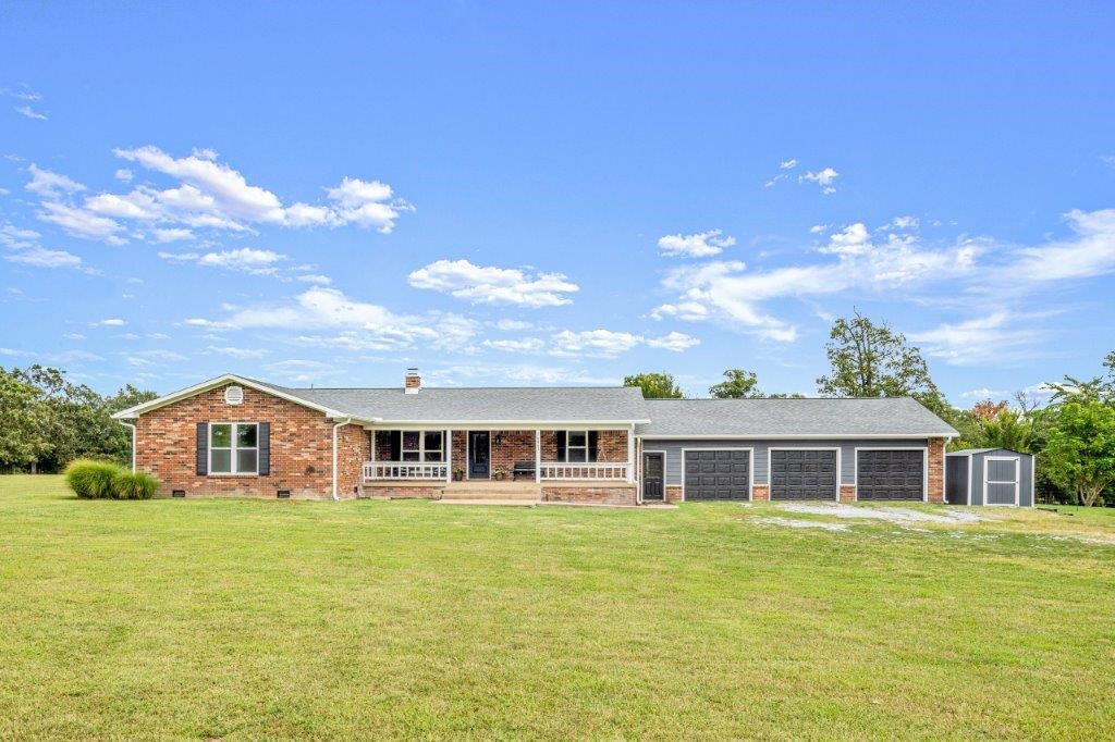 Beautifully remodeled home on 5 Acres w/Barn! Located w/quick access to I-49 for easy travel to all NWA! Multiple living areas & open layout. Sitting at end of well-kept drive, you are welcomed by the large covered porch & curb appeal from the newly updated exterior. Inside the home are wood floors in the entry and formal sitting/dining room. The large eat ā in kitchen has been updated w/granite counters, stainless appliances & abundant cabinetry incl. pantry. Wood burning fireplace vented to family room. Spacious living room has built-ins & access to deck and backyard. Primary suite w/attached bath featuring a gorgeous soaking tub, large shower, double vanity, and his & her WIC. Two guest bedrooms & two guest bathrooms. Large mud room/drop zone off garage entry. Huge 3 car garage offers great space for multiple vehicles and/or workshop. Property also includes a garden space with outbuilding as well as a large barn. Many updates including new HVAC, Roof, Windows & more making this home move in ready!