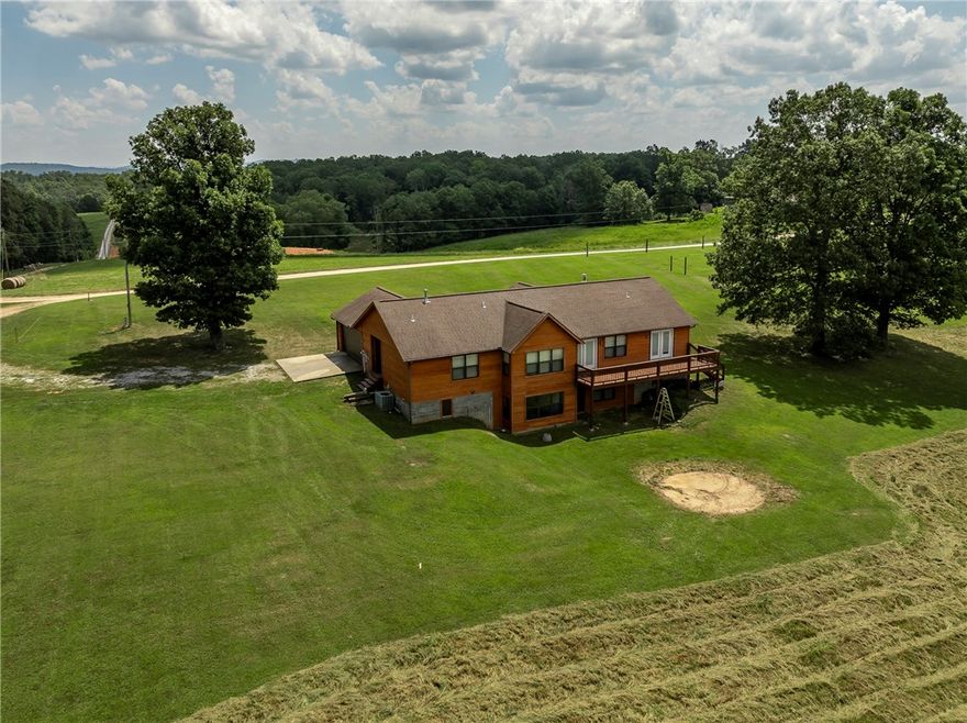 Enjoy peaceful living in this beautiful, custom-built home on 7.38 partially wooded acres, featuring its own year-round spring. The main level features three spacious bedrooms and three baths on the main floor. The partially finished walk-out basement includes an additional half-bath, offering flexible living or storage space. Stylish tile and vinyl plank flooring flow throughout the home with large closets in each bedroom. Energy-efficient double pane windows and six-inch exterior walls provide excellent insulation, keeping you comfortable year-round with reduced utility costs. Step out onto the expansive finished deck, perfect for morning coffee, while enjoying the unobstructed view. This home combines the privacy of country living with modern comfort and convenience. Roof was replaced in February 2026. 2-10 warranty provided to buyer. Your ideal retreat awaits!