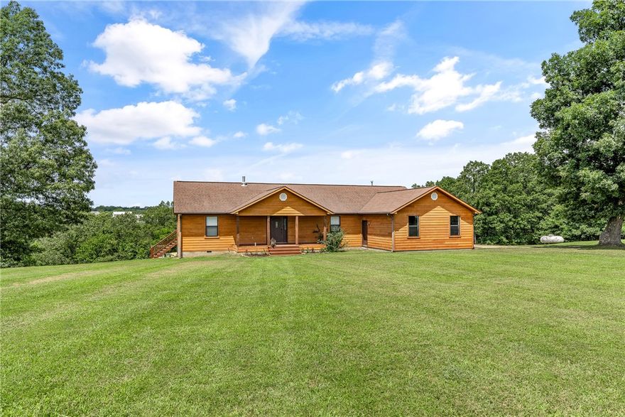 Enjoy peaceful living in this beautiful, custom-built home on 7.38 partially wooded acres, featuring its own year-round spring. The main level features three spacious bedrooms and three baths on the main floor. The partially finished walk-out basement includes an additional half-bath, offering flexible living or storage space. Stylish tile and vinyl plank flooring flow throughout the home with large closets in each bedroom. Energy-efficient double pane windows and six-inch exterior walls provide excellent insulation, keeping you comfortable year-round with reduced utility costs. Step out onto the expansive finished deck, perfect for morning coffee, while enjoying the unobstructed view. This home combines the privacy of country living with modern comfort and convenience. 2-10 warranty provided to buyer. Your ideal retreat awaits!