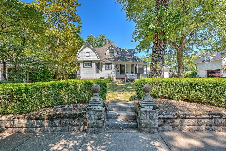 THE ULTIMATE DOWNTOWN BENTONVILLE LOCATION!!!  This fabulous remodeled historic landmark is nestled on a .36 acre lot on one of the most sought after streets in all of NWA!!  Just 6 scenic walking blocks to Bentonville’s city square, enjoy the best of downtown living!  Beautiful wrap around front porch creates a charming curb appeal while the interior features 2 levels of living space with an updated eat-in kitchen, large formal dining space with fireplace, spacious living area, separate breakfast room, main level master retreat, main level guest bedroom, 400 sq ft bonus/office space with private outdoor entrance,  and 3 bedrooms and a full bath on the second floor!  Gorgeous hardwood flooring throughout, all original doors, molding and trim!  Wine cellar/storm shelter!  Private drive with shared electronic security gate!  Unbeatable location with all historic charm of Downtown Bentonville!!