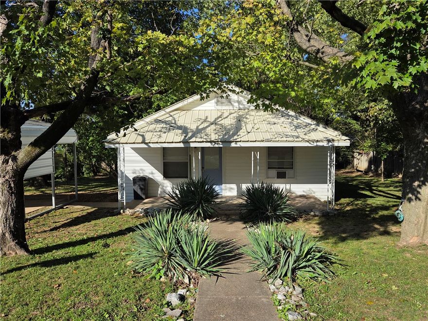 Don't miss this cozy 2 bedroom home in the heart of Berryville within walking distance to the Community Center, Public Square, Library, shopping/restaurants, and more.  

Ready to move in, this home has fresh new paint inside, some new carpet, new A/C window units, and ceiling fans in most rooms. Some extra amenities include a kitchen loaded with all the appliances, large utility room, 8x12 storage shed, nice sized back deck, and a covered front porch. 

The lot is .20 acres with a 2 car carport and nice mature trees. This home is clean and ready to move in! Would make a great starter home, retirement home, or a nice rental. 

Priced to sell quickly so call today to see this home before it's gone!