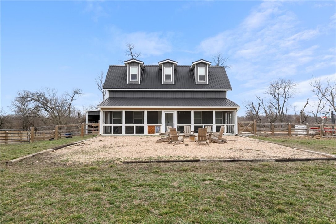 Discover tranquility in this unique shop house, perfectly situated on a beautiful 5.44 acres along Osage Creek, on the sought-after Mill Dam Road.
Key Features Include: Extensive upgrades, featuring a half basketball court, fully fenced pasture, and an equestrian loafing shed or hay storage, Commercial HEPA filter in the shop for clean air. Newly remodeled bathrooms and stylish custom roller shades. The kitchen equipped with butcher block counters.
Property Details: A spacious 30x40 shop on the lower level, complemented by 8x40 porches in both the front and rear. Enjoy morning coffee and breathtaking sunrises on the fully screened front porch.
Ground level includes a small bedroom and a full bath for convenience.
Upstairs is living space, complete with a full bath, kitchen, and cozy built-in twin beds for guests. On-site amenities include a septic system and well. Recent Upgrades:New water heater, gutters, and appliances (all installed in 2023).