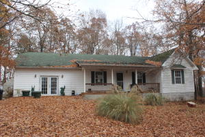 Very unique opportunity with this 3 bedroom 2 bath home just a short distance off pavement with 14 acres m/l, 16x20 heated detached garage with workshop area, 12x8 storage building, 24x6 covered front porch, electric hookup for RV, Native Red Oak cabinets in kitchen, 10x16 sunroom & WB Earth stove. All covering National Forest! All #'s are approx., age & sq. footage per assessor, buyer to verify existence of septic.