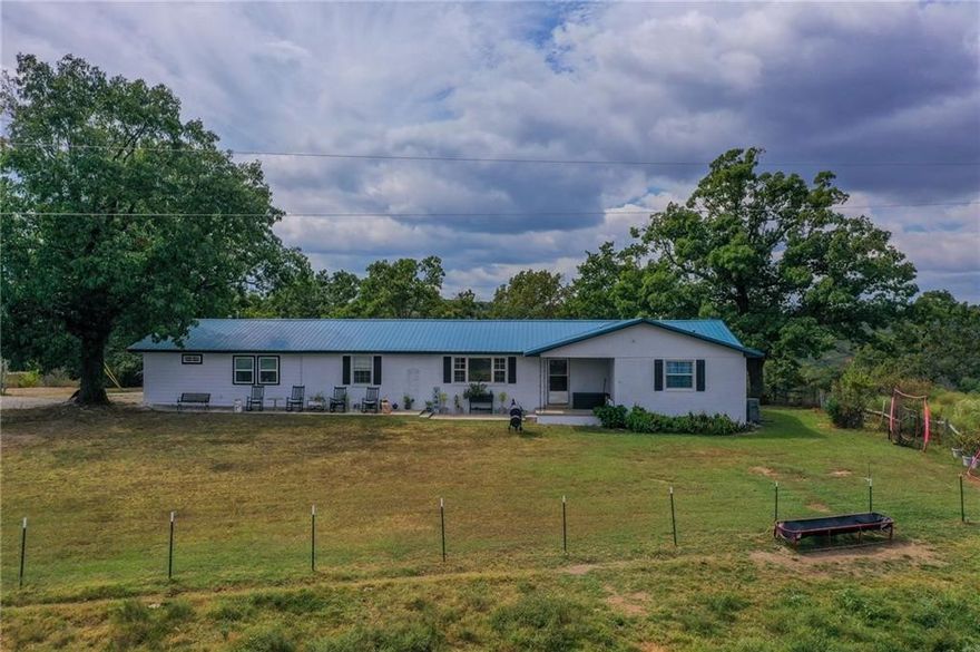 The perfect balance of farm life mixed with ease and convenience of being located 2 minutes from Highway 412. You're close to Fayetteville, Springdale, and Huntsville. The house sits on over 21 acres of land, and is the perfect design for multi-family living. Best of all the property features a storm shelter, barns, and a shop which make it a dream. The gated in ground pool will have you wishing you could swim year round. Be sure to see all that this property has to offer with the video and 3D Matterport tour.