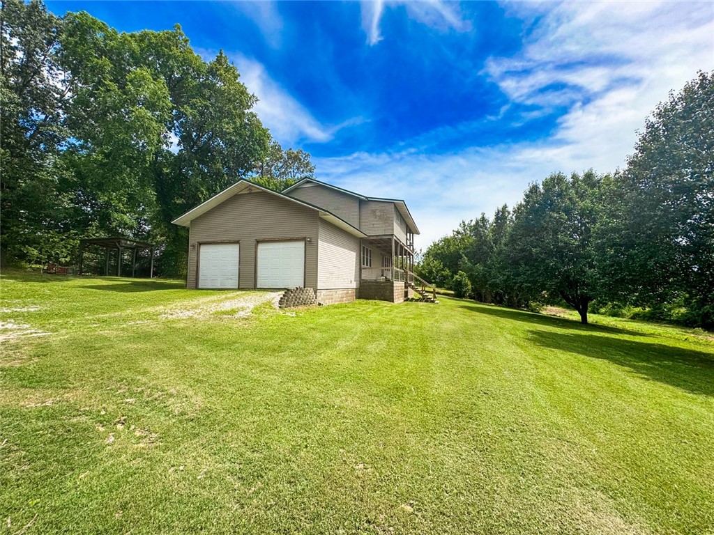 Nestled on a serene 1-acre lot in Bentonville’s tranquil Osage Hills area, this 4-bedroom, 2.5-bathroom home offers a peaceful escape with immense potential. Tucked away from the hustle, it boasts a warm ambiance, perfect for those craving privacy and a chance to craft their dream home. Spacious living and dining areas, filled with natural light, provide ample room for family gatherings, cozy nights, or entertaining guests. The layout serves as a canvas for your personal vision, ideal for updates or custom touches. Aviation enthusiasts will delight in relaxing on the expansive back porch, watching planes flying into, just XNA, which is under 3 minutes away. Outdoor lovers are steps from world-class biking trails like Slaughter Pen and Coler Mountain, offering endless adventure. A short drive to downtown Bentonville’s vibrant dining, arts scene, and Crystal Bridges Museum blends seclusion with NWA’s cultural pulse. Seize this unique opportunity to create your ideal retreat—schedule your private tour today!