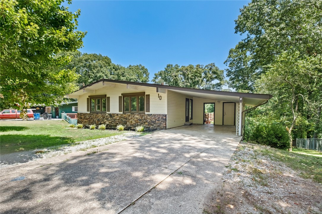 Tons of natural light make this newly remodeled home in Bella Vista stand out. Open concept layout near Tunnel Vision MTB trail in Bella Vista with updated flooring, kitchen, paint, all new appliances convey. Home sits with a flat front yard and gently sloping backyard. Walk out basement offers extra storage / workshop not included in listed square footage.