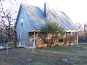 Like New Custom Built Home offers rustic charm & comfortable living. You will love the private setting of this lovely 3BR,2BA home nestled in the woods on 91/2 rolling acres just a few minutes from town. The one owner home offers lots of cabinets, closet space, & windows, spacious living room w/wood burning stove, wrap around deck, 6'' walls, dual heat pumps, oversize garage, det. carport, & more!