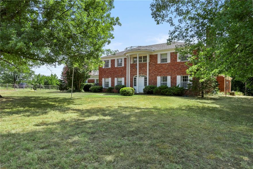 Want to live in the country, yet walk to Fayetteville Athletic Club? Want tons of elbow room/acreage, but be on campus/shopping/or at your favorite eatery in less than 10 minutes? Then welcome home! This is a true rarity, 7.43 acres in the middle of town with quick access to all Fayetteville/Northwest Arkansas has to offer! Beautiful (one-owner) 2-story Colonial home on secluded acreage, at the end of a quiet/peaceful cul-de-sac. This timeless home boasts two kitchens, and two bedrooms upstairs with direct access to a spacious deck that overlooks the entire property. Three rooms have flexibility to be either living/family/dining, with endless possibilities and ability to interchange easily. Large "sunroom" w/second kitchen, could possibly be converted to a mother-in-law quarters/master suite. Your new home is either move-in-ready or a blank canvas to create your dream-space, located on a large/in-town oasis!