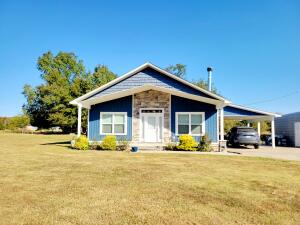 🏡 Charming Beach-Style Home on approx. 1.81 Acres 🌊 This 2-bedroom, 2-bath home combines coastal charm with modern comfort. Open-concept design with plenty of natural light. Gourmet kitchen with soft-close cabinets and a waterfall countertop island. Tankless hot water heater for endless hot water.AC system equipped with a surge protector for reliability. Fruit orchard with apple, pear, and peach trees, along with grape vines. Garden area & also an area featuring raised beds and a dedicated food plot for deer. Storm cellar for added peace of mind. 16x20 shop building for storage or projects. RV hookup with 30 or 50 amps, also water and septic. Close to Lake Atkins.