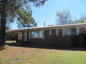 Charming home on the edge of town with hardwood floors, a large living room, 3 bedrooms, 1 1/2 baths, and a nice yard. The double carport offers covered parking and there's plenty of yard for enjoying the outdoors!