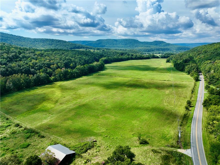 Legacy farm in Madison County, AR, with Hwy 16 frontage and over a mile of White River access. Features hay fields, barns, timber, and fencing for livestock. Incredible hunting with deer, bear, and turkey. Multiple building sites with panoramic Ozark views, rural water, electric, and gas available. A true once-in-a-lifetime opportunity for farming, recreation, or investment.