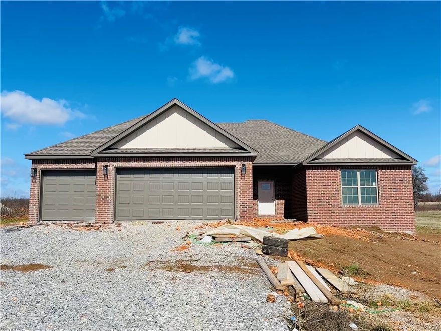 Enjoy the perfect blend of peaceful country living with convenient access to town! This stunning 4-bedroom, 2.5-bath home sits on a spacious 1-acre lot with a 3 car garage, offering privacy and tranquility, approximately 12 miles (20 minutes) to Walmart Home Office in Bentonville, and about 17 minutes to Northwest Arkansas National Airport (XNA).  With 2,204 sq ft of beautifully designed living space, this home features an open floor plan, high-end finishes, and modern touches throughout. Don't wait, schedule your private showing now.  You're going to love this new build, pristine home that's waiting for you!
