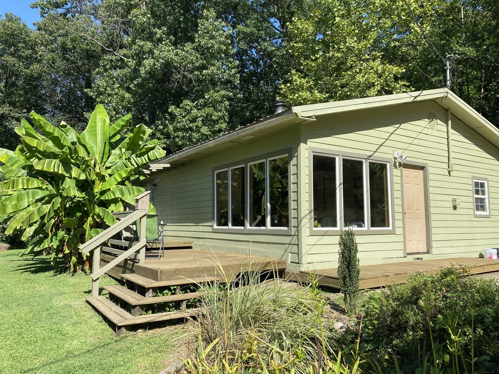 Looking for a cozy home with a country feel just minutes from town? This beautiful location is within walking distance from the White River for those who enjoy fishing, boating, kayaking, or just the simple joys of nature. Owner is willing to sell all furniture, gym equipment, dishes, glassware and other household items. Whether itās an extra source of income or a great place to call home itās a 3 bdrm., 2 bath, sunroom, deck, master bedroom w/private bath & sitting room. All appliances convey. Room to park an RV with RV plug-in already installed. Public boat launch 1/2 mile from home. Centrally located 17 miles from Springdale & 13 miles from Mission & Crossover, Fayetteville. Located on lots 51& 52 Beav-O-Rama subdivision.