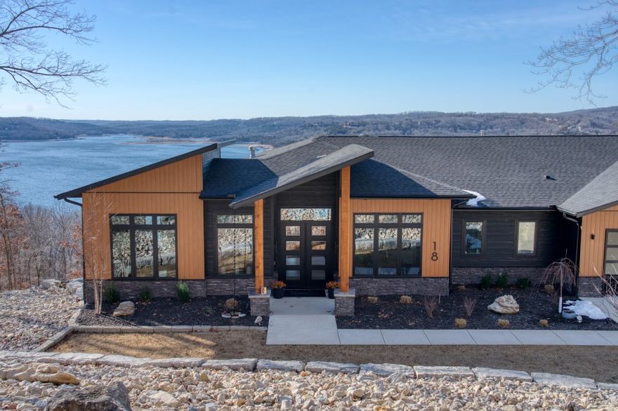 This pristine gem is truly an amazing work of art! Everywhere you turn, there are impressive high-end finishes and it includes a near-by community boat slip! This jaw-dropping view of the Beaver Lake’s main channel is massive! View the beauty of the lake through the four distinct seasons and even watch the Lost Bridge fireworks from your own deck! This perfectly decorated home will impress you with it’s beautiful colors, textures, and tile patterns. It’s huge master bedroom suite is on the main floor and it includes a soaking tub, steam shower, and it’s own laundry. Two large decks let you enjoy the view and the pool, putting green, and firepit are over the top! Spaces include two living rooms, a dedicated home theater room, a gym, and a hidden speak-easy! This home includes an automatic whole house generator for power outages, Culligan water filtration, and distributed audio throughout the entire house (and garage!). The oversized 4-car garage is heated and cooled! Furniture, furnishings, and boat are negotiable.