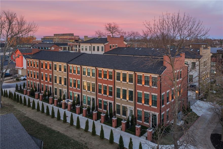 Step into the epitome of luxury and elegance at Oak One, where these Bostonian-classic inspired brownstones redefine upscale urban-living in downtown Bentonville. Each residence exemplifies unparalleled craftsmanship and attention to detail, from the majestic cast stone and brick exteriors to the exclusive private green space courtyards. Designed for discerning tastes, this home features herringbone hardwood floors, elevator, towering solid core custom doors, and bespoke high-end finishes including 24k-gold plated light fixtures and a stunning 1000-light teardrop chandelier. Indulge in the pinnacle of convenience with touches such as Hansgrohe faucets/shower-heads, high-end smart toilets & mirrors, heated towel racks, and counter-depth inset LG appliances throughout. Enjoy a lifestyle of sophistication mere steps away from some of Bentonville's most iconic landmarks such as the Ledger, Pedaler’s Pub, Skylight Theater, the adjacent bike trail and more! Embrace urban luxury at its finest—your home awaits at Oak One.