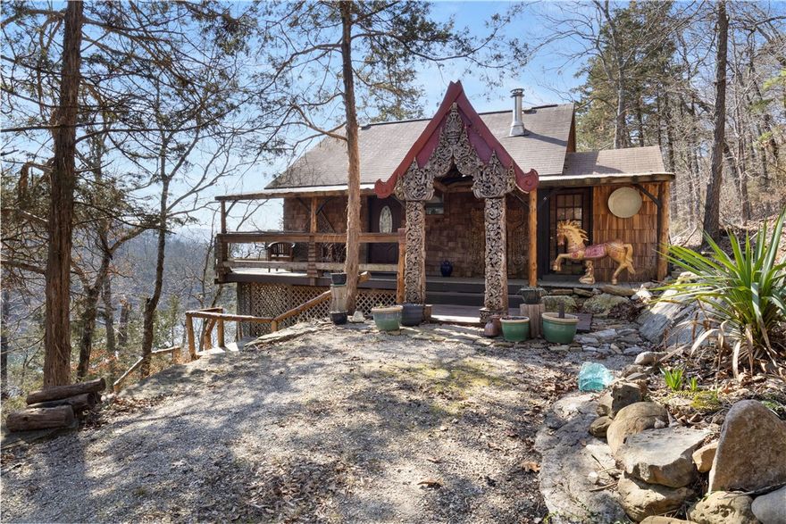 Waterfront Cabin in Private Waterfall Cove on Beaver Lake w/ 3.17 Acres, Dock Slip Available & Rare Future Opportunity! Tucked inside a privately held cove on Beaver Lake, this 3.33-acre property offers a setting that simply cannot be recreated. A year-round waterfall flows into the cove below, creating a peaceful, meditative atmosphere you’ll feel the moment you arrive. The 1-bedroom, 1-bath cabin—crafted by local artisans—is perfectly positioned to take in the view, with over 900 sqft of elevated decking overlooking the waterfall and water’s edge. With multiple potential building sites, the acreage offers the flexibility to expand, create a private compound, or hold as a long-term asset. .25 mile away, is a dedicated boat slip is available to rent in private dock. With a first right of refusal on the remaining portions of this privately held cove—featuring additional acreage, a residence, and 2-slip boat dock—offering a rare opportunity to expand ownership over time in one of Beaver Lake’s most gorgeous settings.